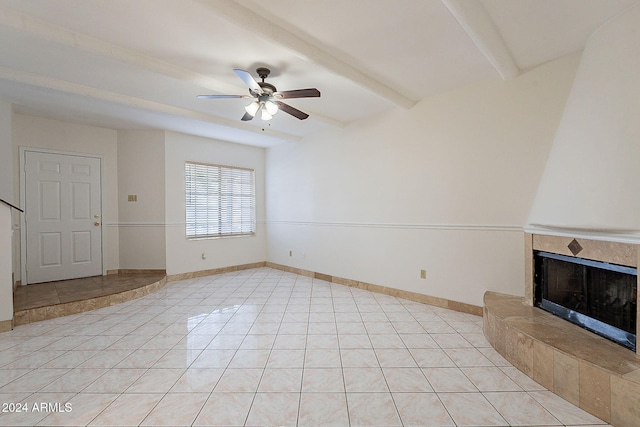 1446 E Grovers Ave Unit 13, Phoenix, AZ 85022 - unfurnished living room featuring a ceiling fan, beamed ceiling, a tile fireplace, and light tile patterned flooring