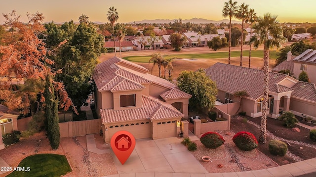 aerial view at dusk featuring a residential view