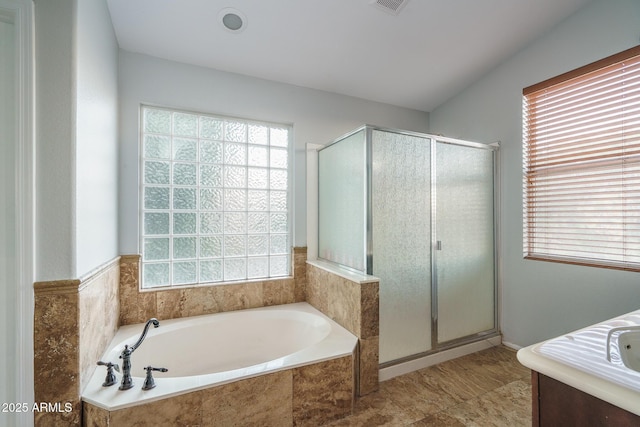 bathroom with visible vents, a garden tub, and a shower stall