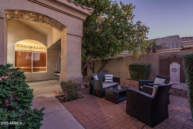 view of patio featuring fence and an outdoor hangout area