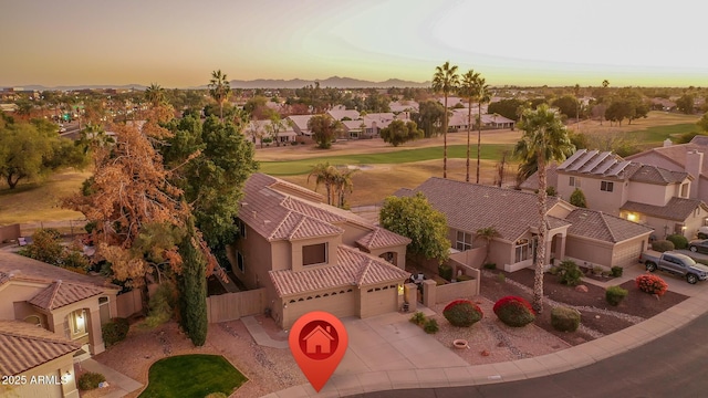 aerial view at dusk featuring a residential view