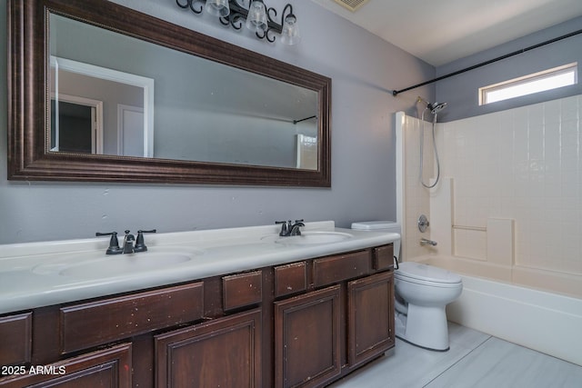 full bath with toilet, double vanity, a sink, and shower / bathtub combination