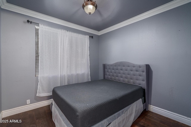 bedroom with crown molding, baseboards, and wood finished floors