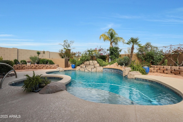 view of pool with a fenced backyard, an in ground hot tub, and a fenced in pool