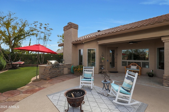 view of patio / terrace with fence, area for grilling, and ceiling fan