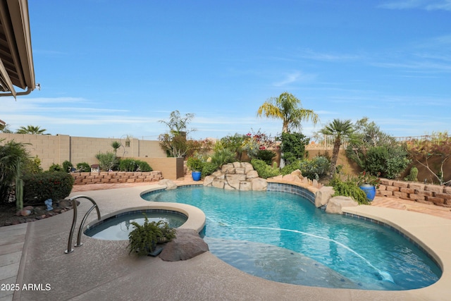 view of swimming pool with a fenced backyard, an in ground hot tub, a fenced in pool, and a patio