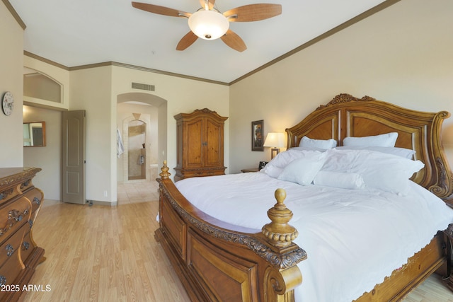 bedroom with visible vents, arched walkways, ornamental molding, a ceiling fan, and light wood-style flooring