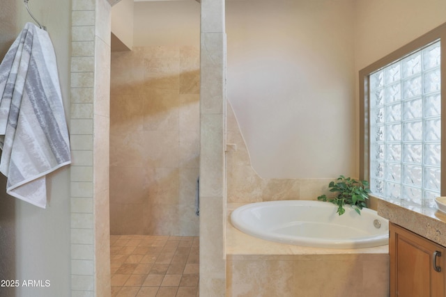 full bath with a bath, walk in shower, and vanity