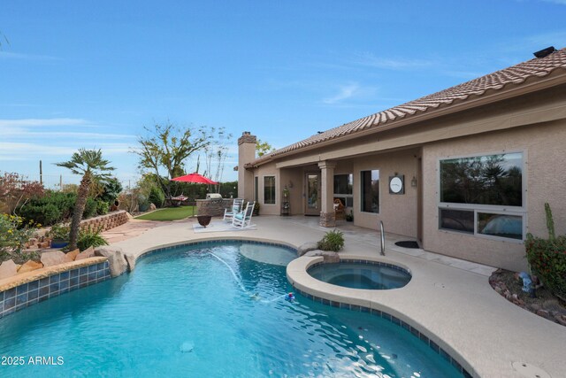 view of pool featuring a patio area and a pool with connected hot tub