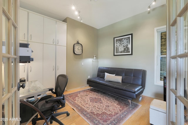 office with baseboards, rail lighting, and wood finished floors