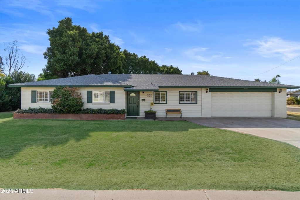 ranch-style house with a garage and a front yard