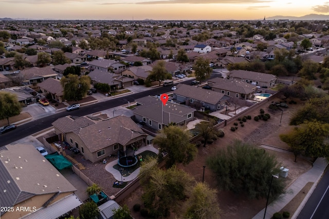 aerial view at dusk featuring a residential view