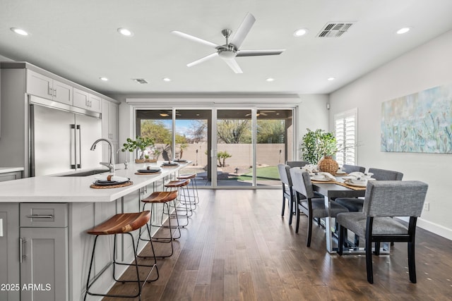 dining room featuring dark wood-type flooring, recessed lighting, visible vents, and baseboards