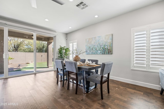 dining space with dark wood-style flooring, recessed lighting, visible vents, and baseboards