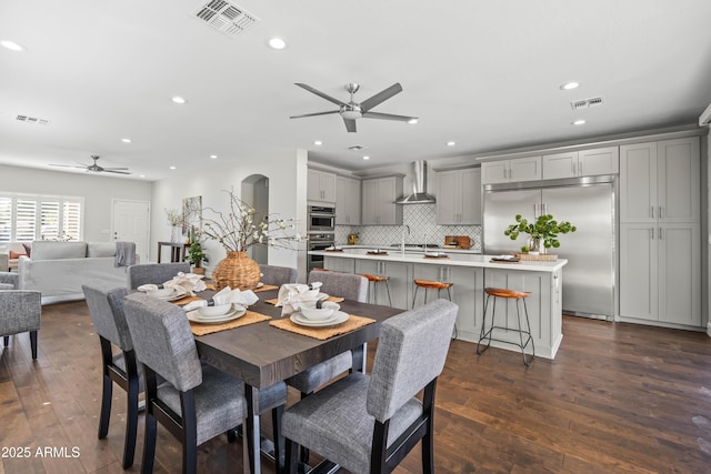 dining area featuring dark wood-type flooring and visible vents