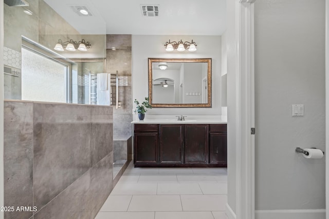 full bathroom featuring a walk in shower, tile patterned flooring, vanity, and visible vents