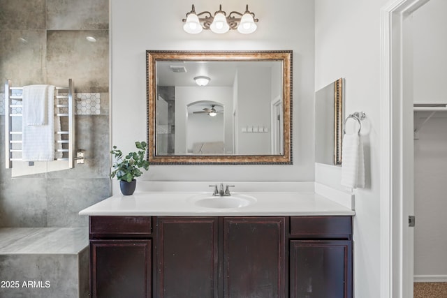 bathroom with a ceiling fan, vanity, and radiator heating unit