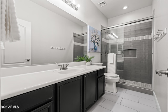 full bathroom featuring toilet, vanity, visible vents, tile patterned floors, and a stall shower