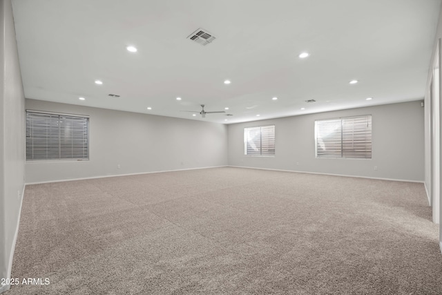 unfurnished room featuring carpet floors, baseboards, visible vents, and recessed lighting