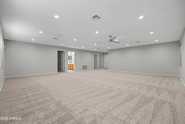 spare room featuring recessed lighting, visible vents, and light carpet