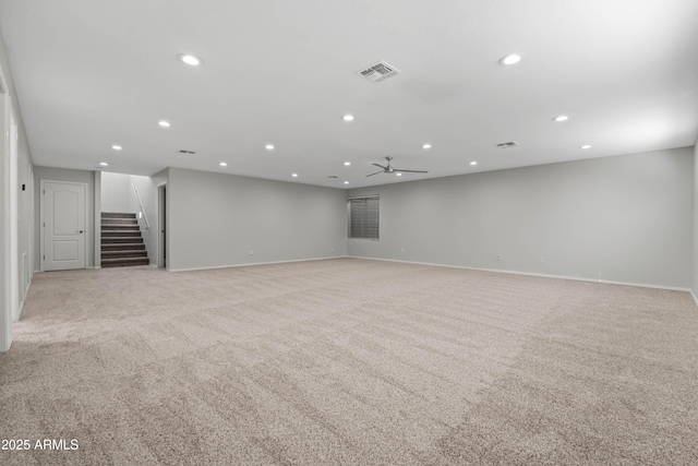 interior space with light carpet, recessed lighting, visible vents, and stairway