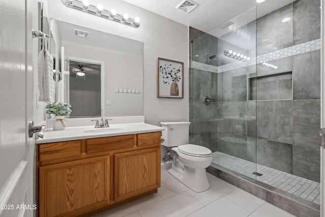 full bath featuring toilet, a tile shower, and visible vents