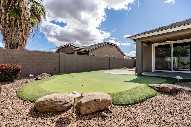 view of yard with a patio area, a fenced backyard, and ceiling fan