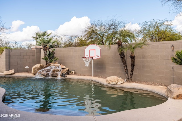 view of swimming pool with fence