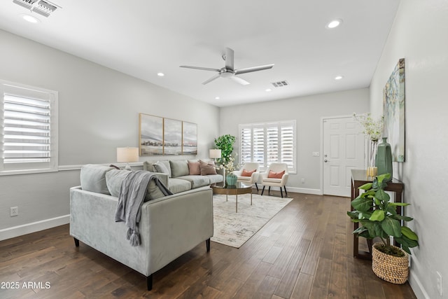 living room with baseboards, visible vents, dark wood-style flooring, and recessed lighting