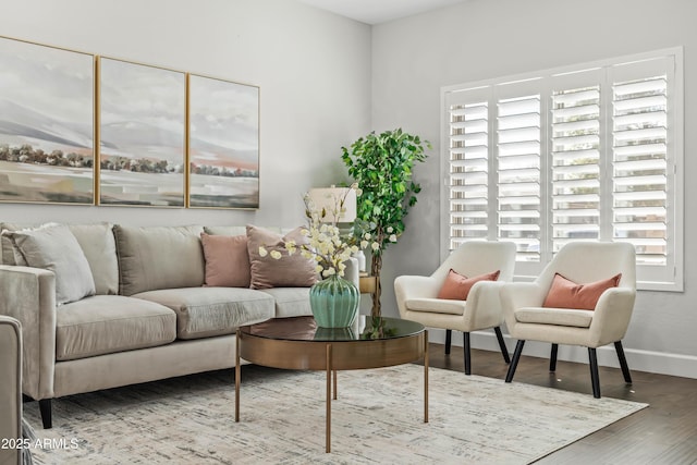 living area with wood finished floors and baseboards