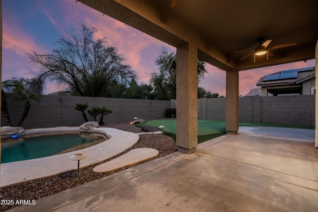 view of patio / terrace featuring a fenced backyard, a fenced in pool, and a ceiling fan