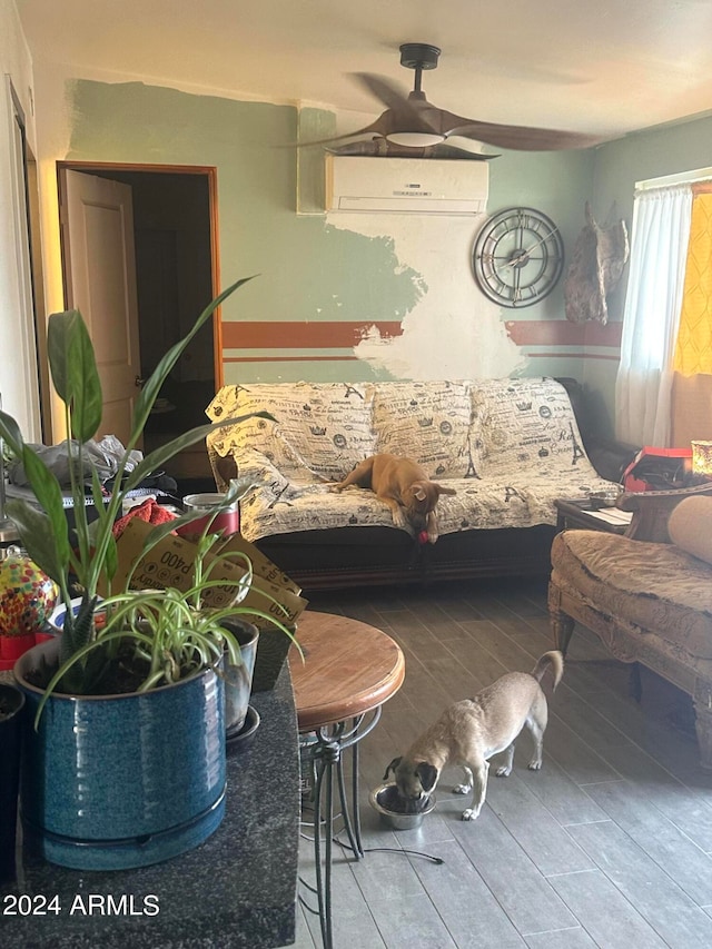 bedroom with an AC wall unit, ceiling fan, and hardwood / wood-style floors