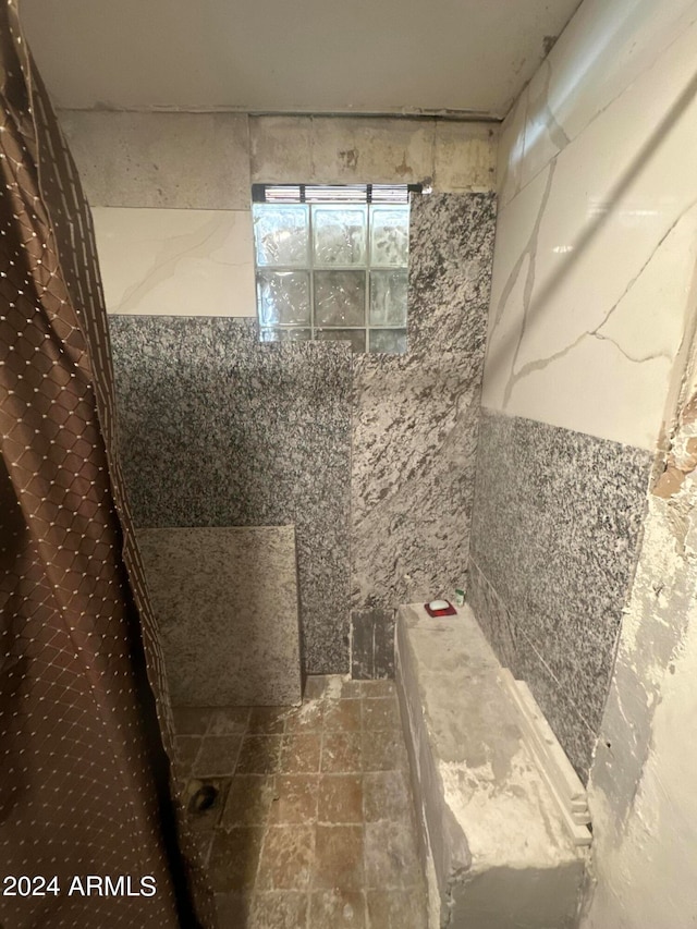 bathroom featuring tile floors and tile walls