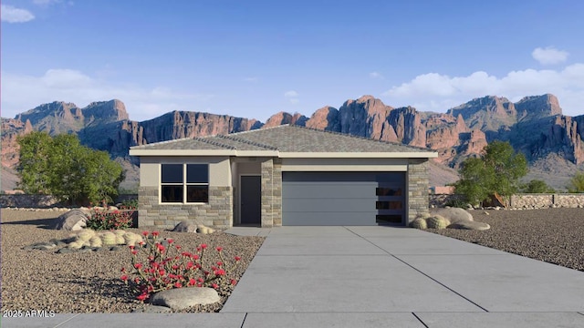 18362 W Hackamore Dr, Wittmann, AZ 85361 - view of front of home featuring stone siding, a garage, concrete driveway, and a mountain view