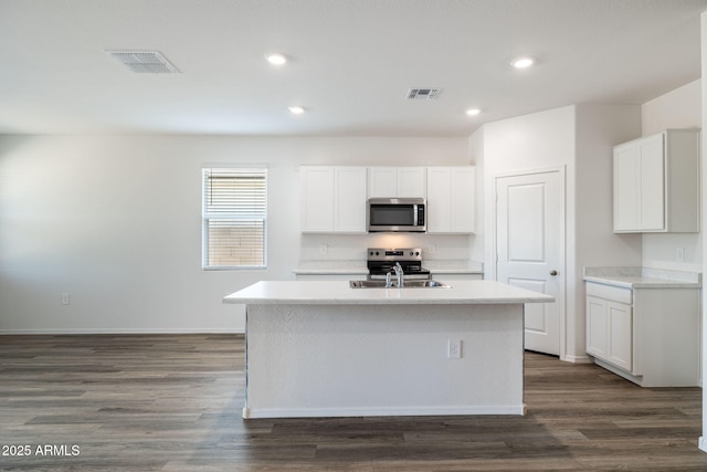 18362 W Hackamore Dr, Wittmann, AZ 85361 - kitchen with stainless steel appliances, a center island with sink, light countertops, white cabinetry, and recessed lighting
