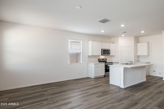 18362 W Hackamore Dr, Wittmann, AZ 85361 - kitchen featuring appliances with stainless steel finishes, dark wood-style floors, white cabinetry, an island with sink, and recessed lighting