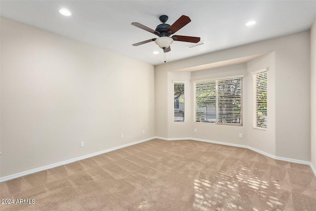 empty room featuring light carpet and ceiling fan