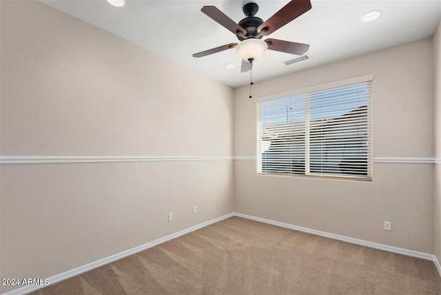 spare room featuring carpet flooring and ceiling fan