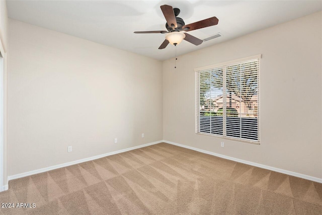 carpeted spare room with ceiling fan