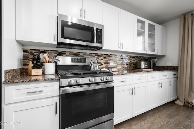 17 W Vernon Ave Unit 412, Phoenix, AZ 85003 - kitchen with glass insert cabinets, appliances with stainless steel finishes, tasteful backsplash, and dark stone countertops
