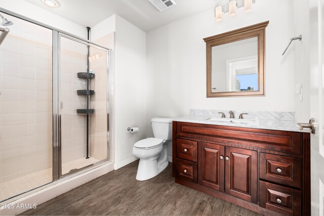 17 W Vernon Ave Unit 412, Phoenix, AZ 85003 - bathroom featuring visible vents, a stall shower, wood finished floors, vanity, and toilet