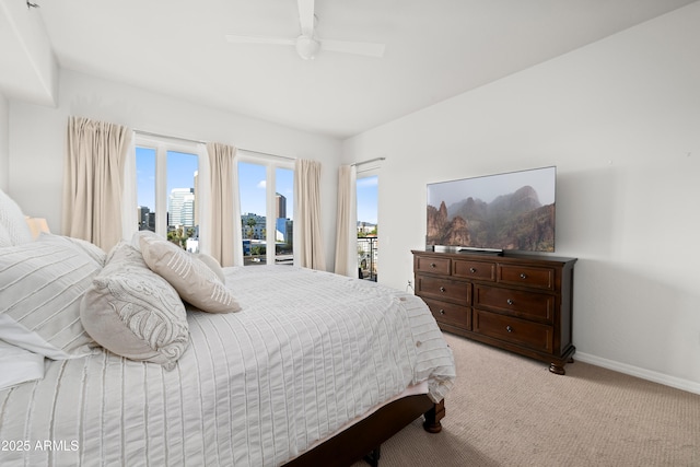 17 W Vernon Ave Unit 412, Phoenix, AZ 85003 - bedroom featuring baseboards, a ceiling fan, light carpet, and access to exterior