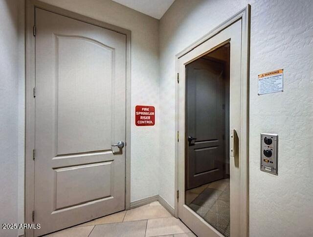 17 W Vernon Ave Unit 412, Phoenix, AZ 85003 - entryway with baseboards, a textured wall, and light tile patterned flooring