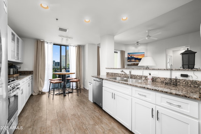 17 W Vernon Ave Unit 412, Phoenix, AZ 85003 - kitchen featuring a sink, appliances with stainless steel finishes, dark stone counters, and visible vents