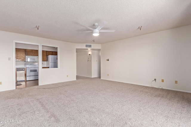 unfurnished living room with ceiling fan, a textured ceiling, and carpet