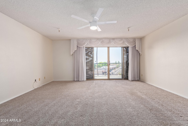 carpeted spare room with ceiling fan and a textured ceiling