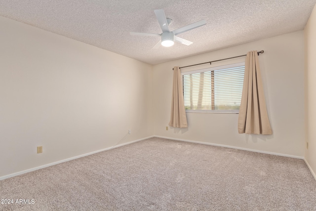 empty room with ceiling fan, a textured ceiling, and carpet floors