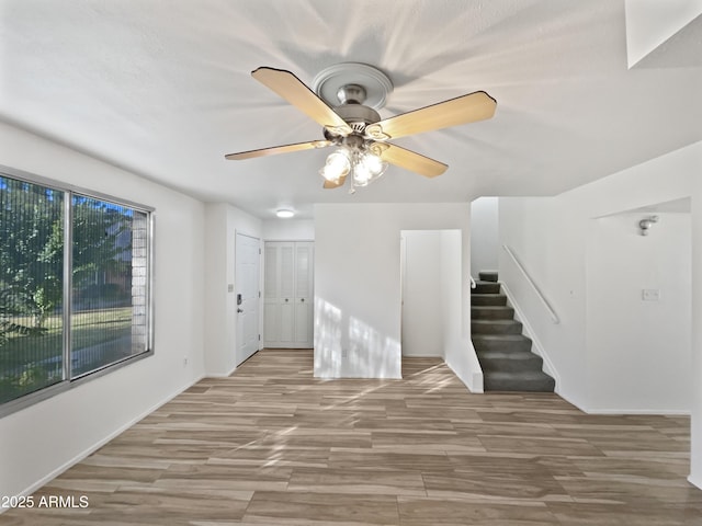 unfurnished living room with light hardwood / wood-style flooring, a wealth of natural light, and ceiling fan