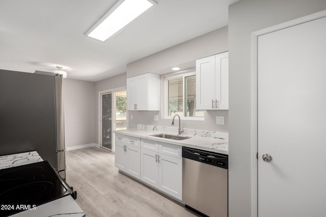 kitchen featuring white cabinets, light stone counters, sink, and stainless steel appliances