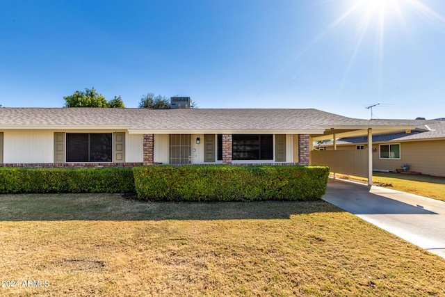 single story home featuring a front yard, a carport, and cooling unit